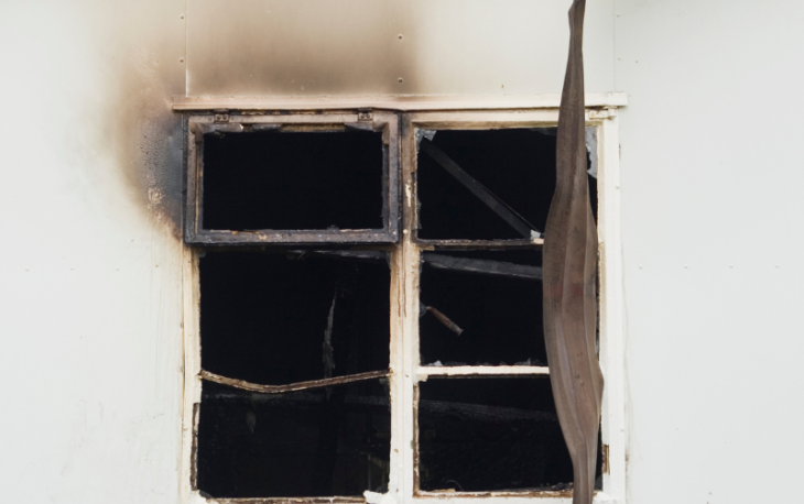 House window showing signs of smoke damage